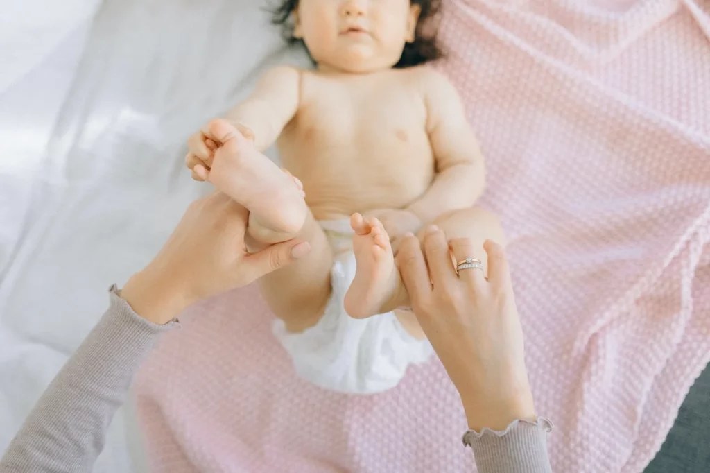 How to relieve gas in newborn baby through bicycling massage